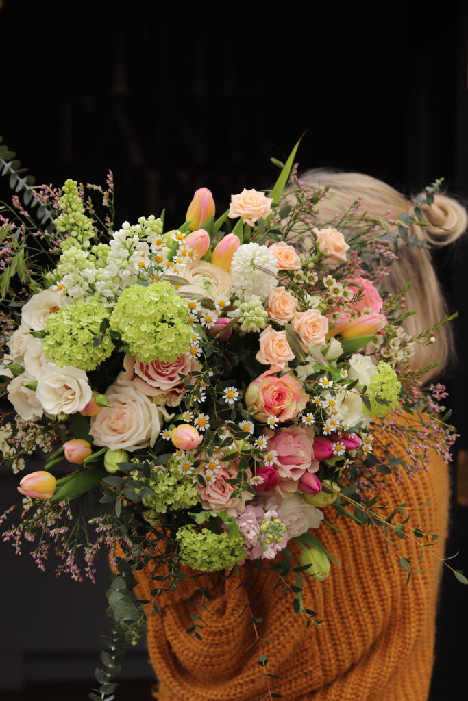 Spring garden bouquet with roses, tulips, lilac and guelder rose